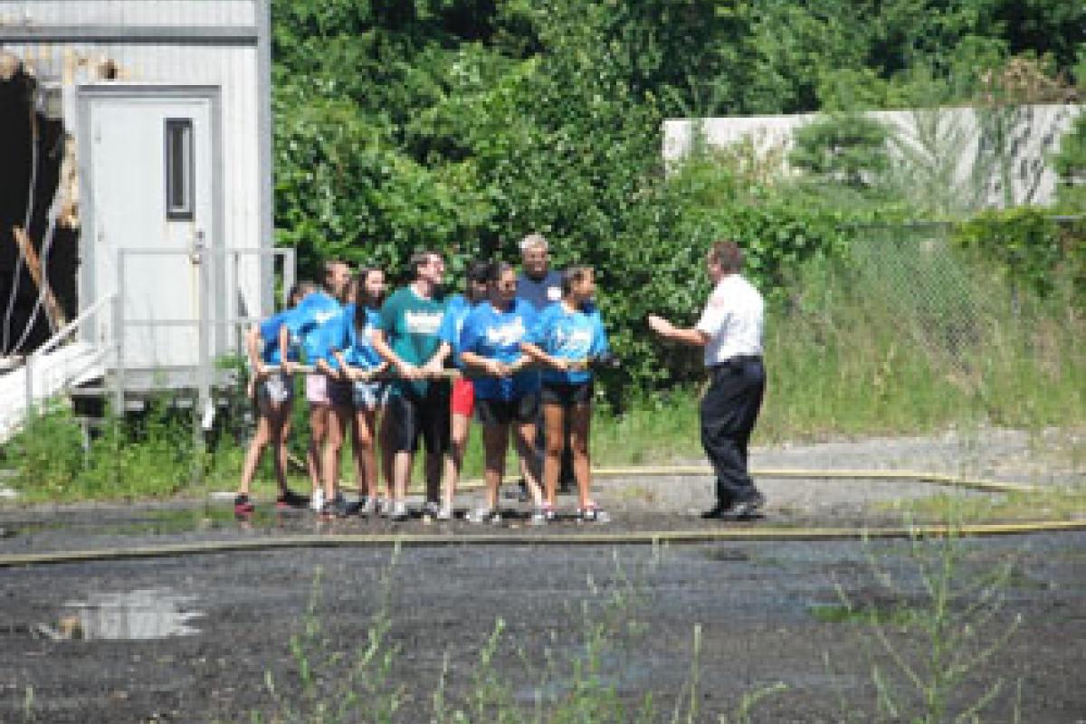 Lt. Scott Perry instructs the campers during hoseline activity